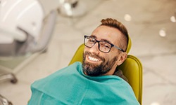Smiling dental patient in treatment chair