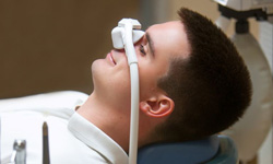 Relaxed male patient wearing nitrous oxide mask