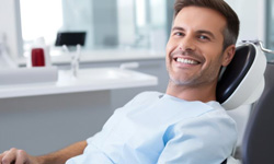 Happy patient relaxing in dental chair