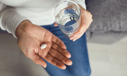 Woman preparing to swallow a sedative pill