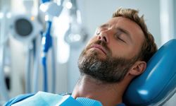 Relaxed man reclined in dental treatment chair