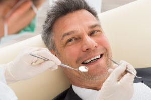 man smiling in the dental chair