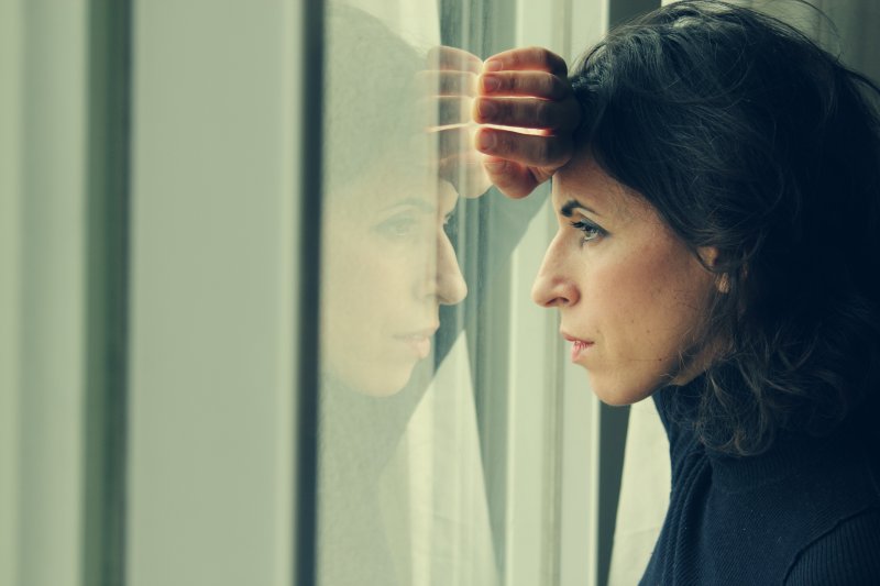 A woman staring out of a window.