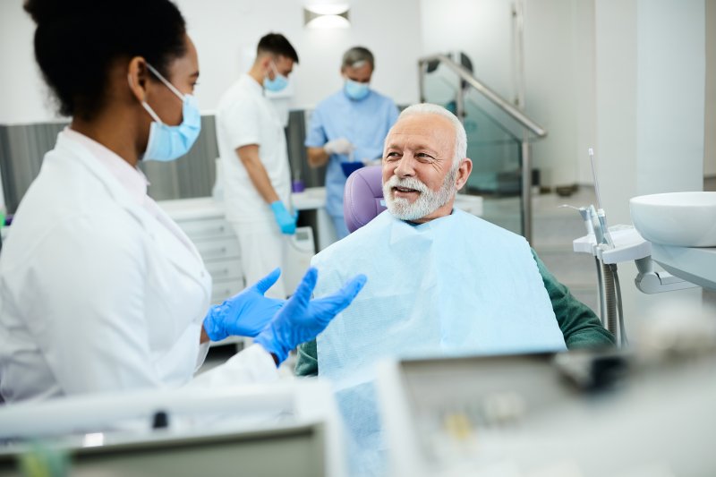 Older man completing a dental implant consultation in Frisco