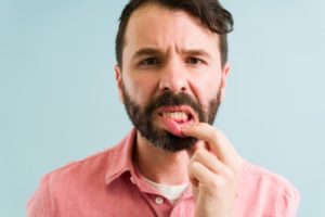 man looking at his gums 